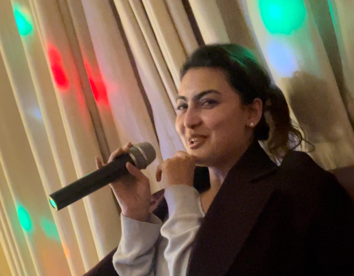 Ranjana smiling with a microphone in a candid moment